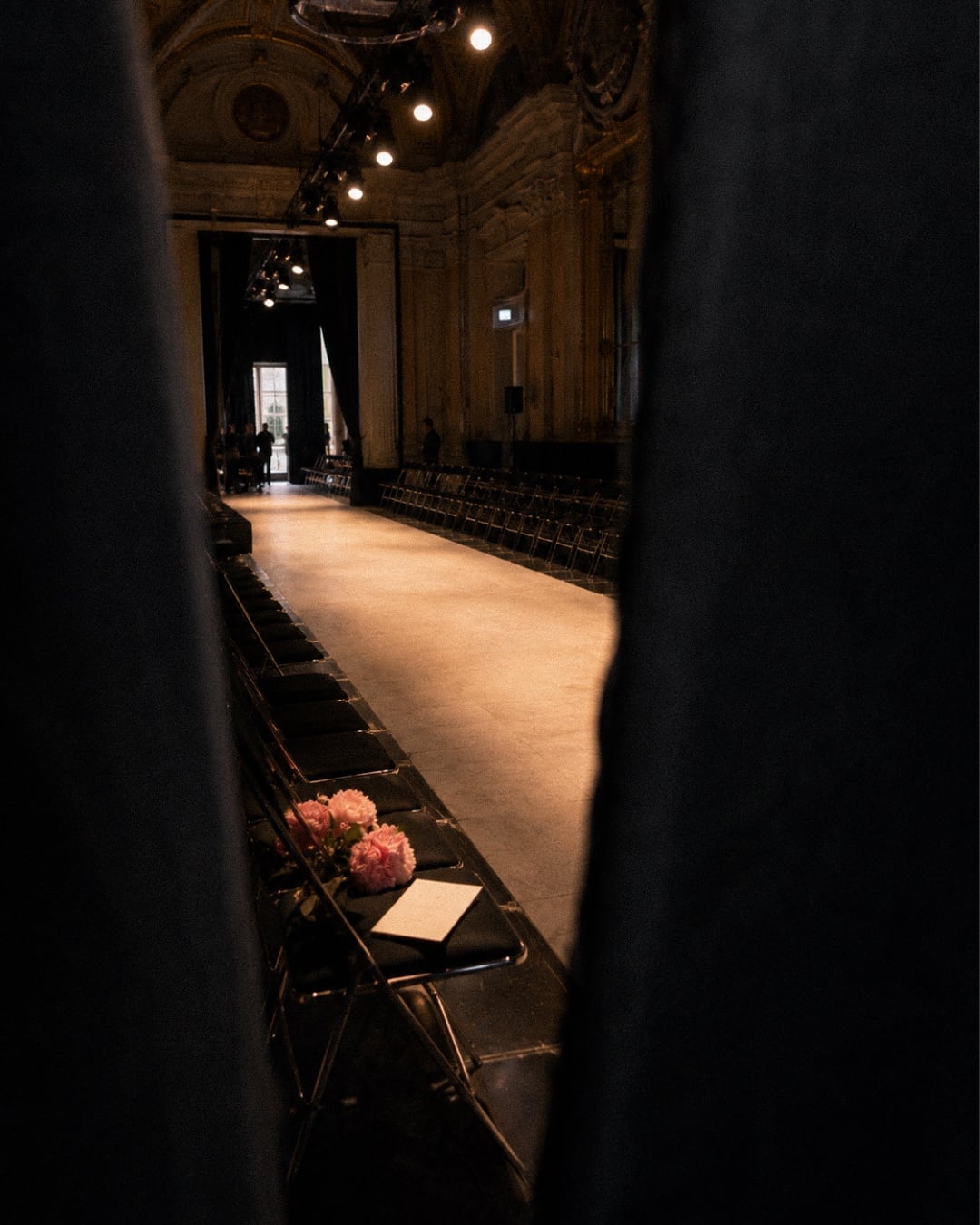 Between shows: The empty runway, through the curtain